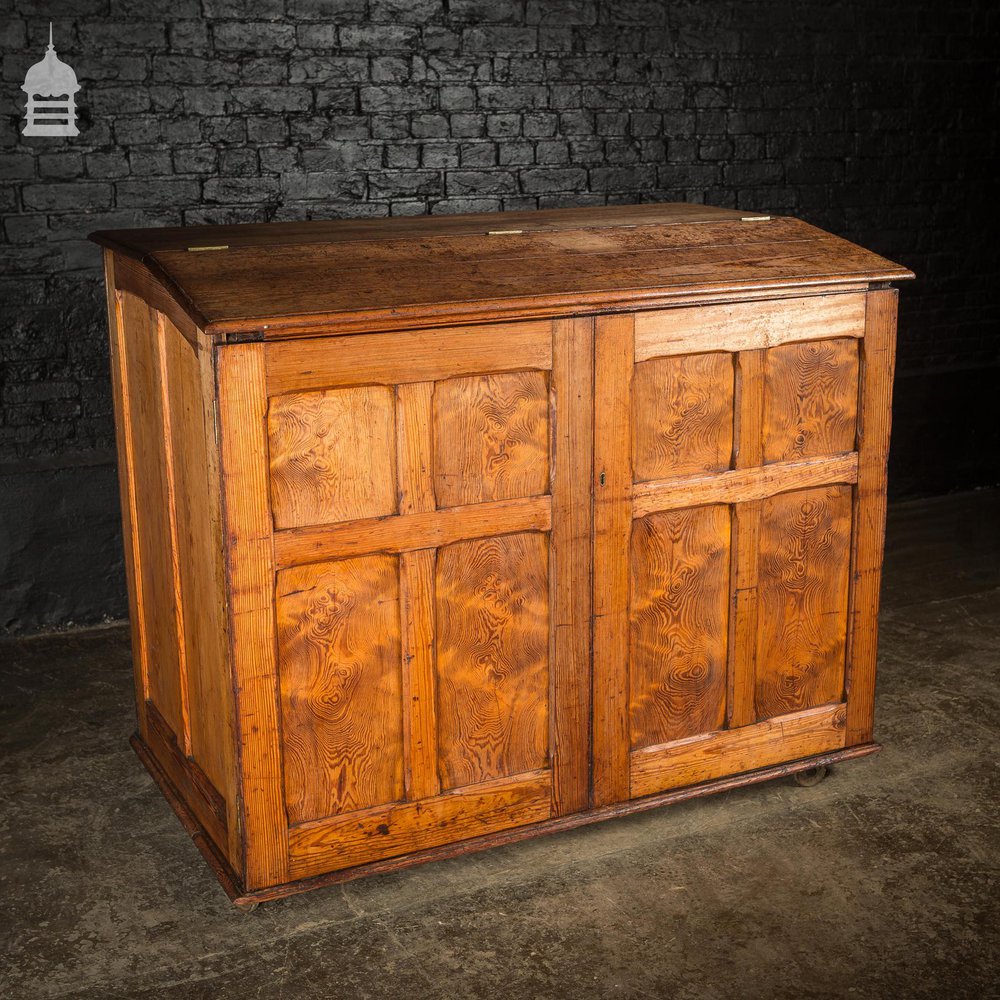 Large 19th C Figured Pitch Pine Ecclesiastical Cupboard with Double Doors, Opening Top and Metal Castors