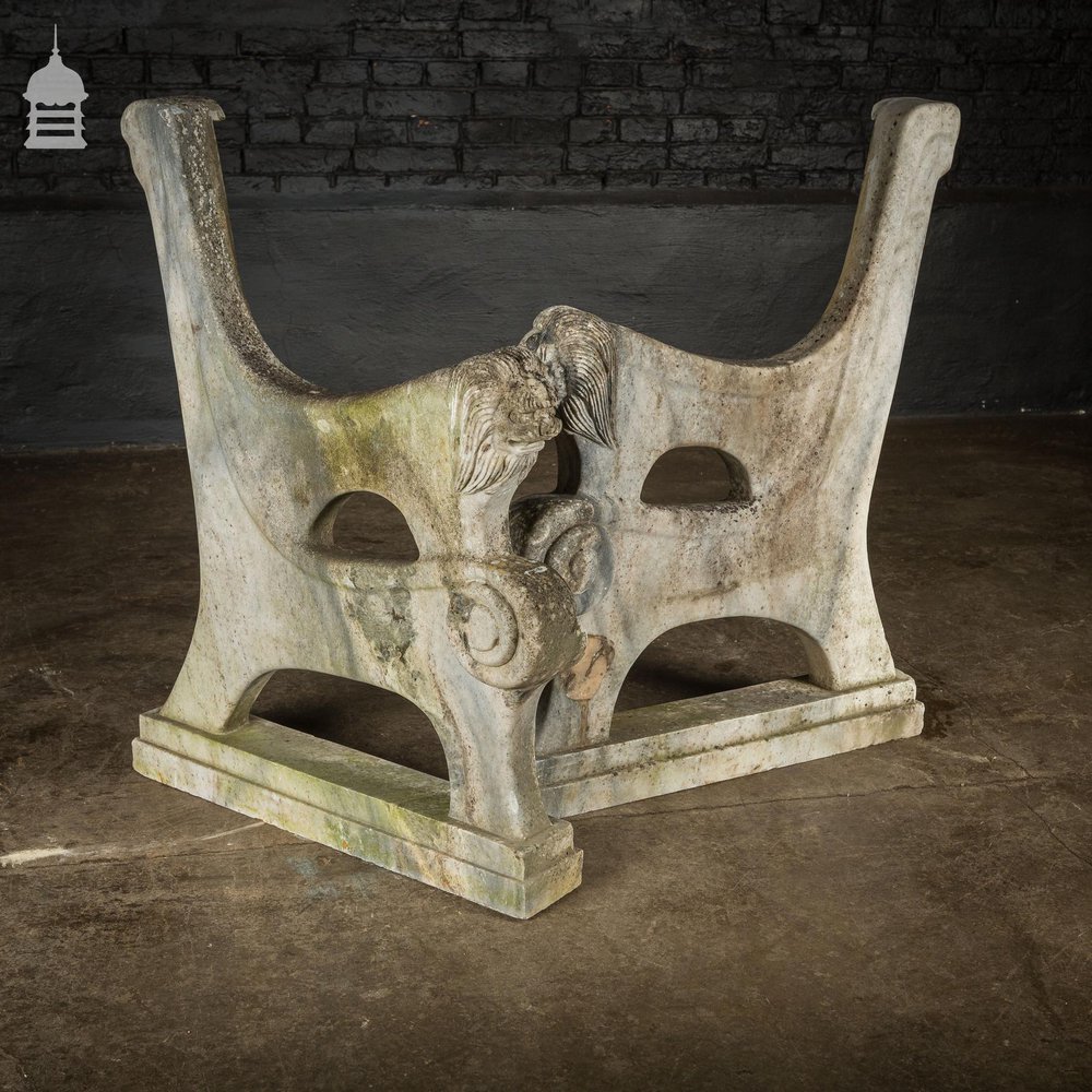 Pair of Weathered Marble Bench Ends with Carved Dragon Design