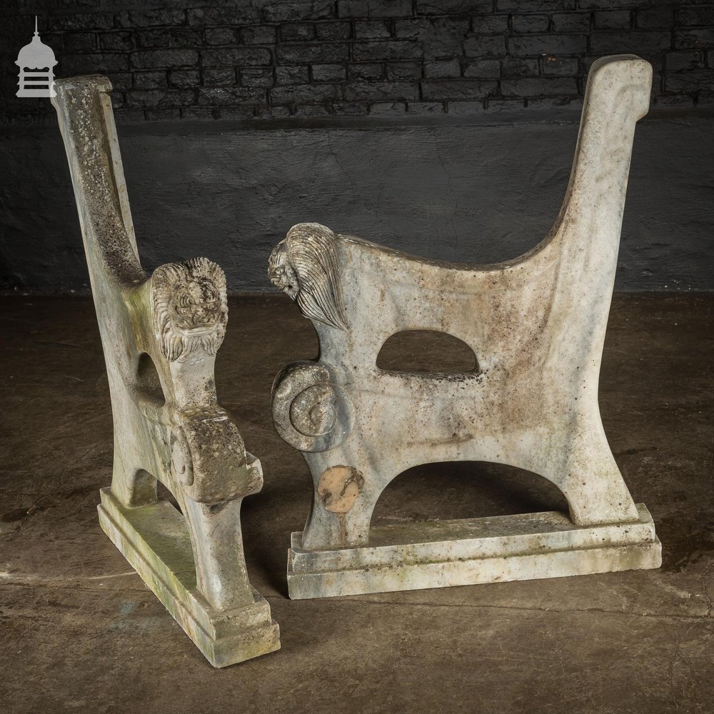 Pair of Weathered Marble Bench Ends with Carved Dragon Design