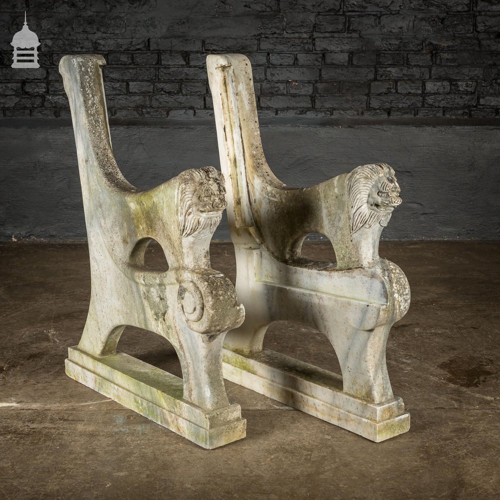 Pair of Weathered Marble Bench Ends with Carved Dragon Design