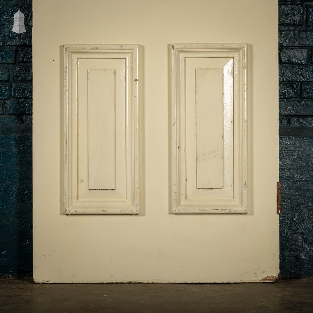 Heavy fire door with mouldings on one side to create panelled appearance.