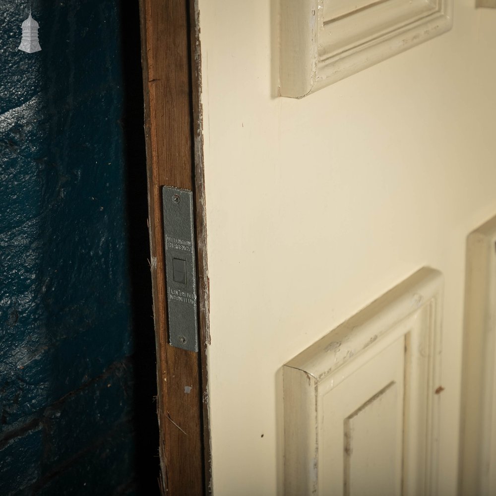 Heavy fire door with mouldings on one side to create panelled appearance.